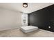 A carpeted bedroom features a modern black accent wall and a sunlit window at 2949 Clever Ln, Winter Park, FL 32792