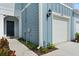 Townhome exterior displaying the front door, a one-car garage, and fresh landscaping at 2949 Clever Ln, Winter Park, FL 32792