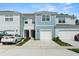 Charming light-blue townhome showcases a clean-looking garage door and well-manicured landscaping at 2949 Clever Ln, Winter Park, FL 32792