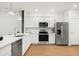 Bright kitchen featuring stainless steel appliances, white cabinets, and sleek countertops at 2949 Clever Ln, Winter Park, FL 32792