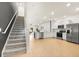 Open-concept kitchen with stainless steel appliances, white cabinets, and wood flooring at 2949 Clever Ln, Winter Park, FL 32792