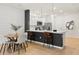 Contemporary kitchen with an island, white cabinetry, stainless steel appliances, and barstool seating at 2949 Clever Ln, Winter Park, FL 32792