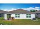 Backyard view showcasing a well maintained lawn and the home's exterior at 3216 Casa Del Rey Ave, Kissimmee, FL 34746