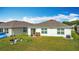 Wide shot of backyard with grass, patio, exterior and blue sky at 3216 Casa Del Rey Ave, Kissimmee, FL 34746
