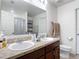 Bathroom with double sinks, granite countertops, and a large mirror at 3216 Casa Del Rey Ave, Kissimmee, FL 34746