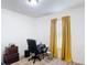 Functional bedroom featuring a desk, chair, carpet and a window with yellow drapes at 3216 Casa Del Rey Ave, Kissimmee, FL 34746