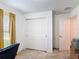 Well-lit bedroom with double closet, carpet, and a partially viewed desk and chair at 3216 Casa Del Rey Ave, Kissimmee, FL 34746