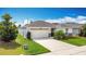 Well-maintained single-Gathering home featuring a spacious driveway and lush green lawn at 3216 Casa Del Rey Ave, Kissimmee, FL 34746