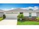 Charming single-story home with a well-manicured lawn and a two-car garage at 3216 Casa Del Rey Ave, Kissimmee, FL 34746