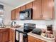 Well-equipped kitchen with dark wood cabinetry and modern appliances at 3216 Casa Del Rey Ave, Kissimmee, FL 34746