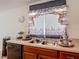 Kitchen featuring a double sink with a decorative curtain and neutral countertops at 3216 Casa Del Rey Ave, Kissimmee, FL 34746
