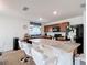 Kitchen featuring wood cabinets, an island with seating and black appliances at 3216 Casa Del Rey Ave, Kissimmee, FL 34746