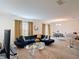 Bright and spacious living room with a large blue couch and dining area at 3216 Casa Del Rey Ave, Kissimmee, FL 34746