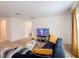 Bright living room with a blue sofa, glass coffee table, and a television on a stand at 3216 Casa Del Rey Ave, Kissimmee, FL 34746