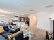 Open-concept living room with blue sofa connecting to a kitchen and dining area at 3216 Casa Del Rey Ave, Kissimmee, FL 34746