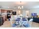 Open-concept living space with dining area and kitchen featuring barstool seating at 3216 Casa Del Rey Ave, Kissimmee, FL 34746