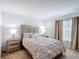 Bedroom with neutral color scheme featuring a large bed and matching nightstands at 3216 Casa Del Rey Ave, Kissimmee, FL 34746