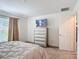 Bedroom with a large bed, dresser, and natural light from the window at 3216 Casa Del Rey Ave, Kissimmee, FL 34746