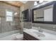 Bathroom with shower and tub combination, framed mirror and vanity at 352 Inglenook Cir, Winter Springs, FL 32708