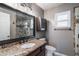 Bathroom featuring granite counters, dark wood cabinets, tile accents, and glass enclosed shower at 352 Inglenook Cir, Winter Springs, FL 32708