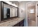 Bathroom with a large mirror, granite counters, dark wood cabinets, and an entrance to a water closet at 352 Inglenook Cir, Winter Springs, FL 32708