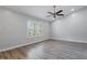 Bright bedroom boasts luxury vinyl plank flooring, large window with stylish shutters, and modern ceiling fan at 352 Inglenook Cir, Winter Springs, FL 32708