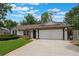 Charming one-story home with a well-manicured lawn and an attached two-car garage at 352 Inglenook Cir, Winter Springs, FL 32708