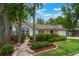 Lovely one-story home with manicured landscaping, a stone walkway, and an attached two-car garage at 352 Inglenook Cir, Winter Springs, FL 32708