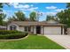 Charming one-story home with a well-manicured lawn and an attached two-car garage at 352 Inglenook Cir, Winter Springs, FL 32708