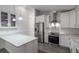 Modern kitchen featuring stainless steel appliances, white cabinetry, quartz countertops, and tile backsplash at 352 Inglenook Cir, Winter Springs, FL 32708