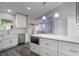 Bright kitchen featuring quartz countertops, stainless steel appliances, white cabinets, and luxury vinyl plank flooring at 352 Inglenook Cir, Winter Springs, FL 32708