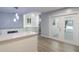 Bright kitchen featuring quartz countertops, stainless steel appliances, white cabinets, and luxury vinyl plank flooring at 352 Inglenook Cir, Winter Springs, FL 32708