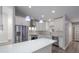 Bright kitchen featuring quartz countertops, stainless steel appliances, white cabinets, and luxury vinyl plank flooring at 352 Inglenook Cir, Winter Springs, FL 32708