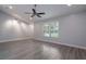 Living room featuring gray walls, hardwood floors, window with natural lighting and ceiling fan at 352 Inglenook Cir, Winter Springs, FL 32708