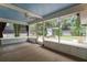 Screened-in porch featuring a ceiling fan, brick fire pit, and access to the fenced yard at 352 Inglenook Cir, Winter Springs, FL 32708