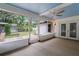 Screened-in patio with ceiling fan, brick fire pit, and backyard views at 352 Inglenook Cir, Winter Springs, FL 32708