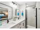 Modern bathroom with a double sink vanity, tiled shower, and black fixtures at 38 Malauka Dr, Ocklawaha, FL 32179
