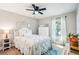 Inviting bedroom with bright natural light, stylish decor, and a ceiling fan at 38 Malauka Dr, Ocklawaha, FL 32179