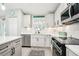 Modern white kitchen with stainless steel appliances at 38 Malauka Dr, Ocklawaha, FL 32179