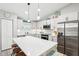 Modern kitchen with white cabinets, stone countertops, and stainless steel appliances at 38 Malauka Dr, Ocklawaha, FL 32179