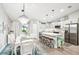 Modern kitchen and dining room with white cabinets and stainless steel appliances at 38 Malauka Dr, Ocklawaha, FL 32179