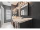 Modern bathroom featuring dual sinks, modern tile accents, and neutral color palette at 415 Old Farm Ln, Winter Springs, FL 32708