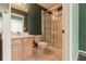 Bathroom with glass-enclosed shower, vanity, and neutral tile floors at 415 Old Farm Ln, Winter Springs, FL 32708