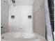 Luxurious bathtub with tile surround and shower head fixture at 415 Old Farm Ln, Winter Springs, FL 32708