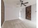 Spacious bedroom featuring a ceiling fan and unique wood accent walls at 415 Old Farm Ln, Winter Springs, FL 32708