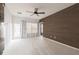 Bright bedroom featuring a ceiling fan, wood wall accents, and private balcony access at 415 Old Farm Ln, Winter Springs, FL 32708