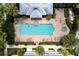 Aerial view of a community pool and spa with sun loungers and lush palm trees at 415 Old Farm Ln, Winter Springs, FL 32708