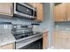 This well-equipped kitchen includes stainless steel appliances, granite countertops and bright lighting at 415 Old Farm Ln, Winter Springs, FL 32708