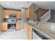 This spacious kitchen has stainless steel appliances, lots of natural light and gorgeous granite countertops at 415 Old Farm Ln, Winter Springs, FL 32708