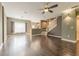 This bright living room features hardwood floors, a ceiling fan, and large windows to let in tons of natural light at 415 Old Farm Ln, Winter Springs, FL 32708